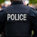 VIDEO: Romo Stop Explodes – Refusal Twist Stuns Cops Back view of a police officer wearing a uniform with 'POLICE' displayed