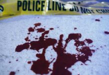 VIDEO: Ambush Kills Cop, Wounds 4 More Blood stains on a surface with police caution tape in the background