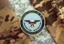 Patriot Shortage Panic? Department of War insignia on camouflage fabric