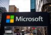 Microsoft Slashes Thousands, Blames… Not AI? Microsoft logo displayed on a textured wall