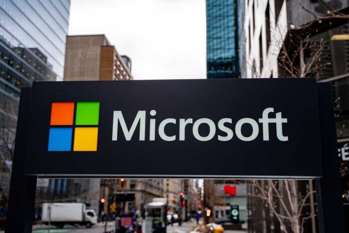 Close,Up,Of,Microsoft,Logo,Sign,On,Modern,Office,Building Microsoft logo displayed on a textured wall