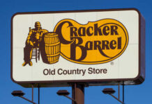 Cracker Barrel Old Country Store sign featuring a man sitting next to a barrel