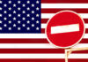A no entry sign in front of the American flag