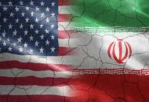 War Windfall Sparks Trump Fury Flags of the United States and Iran blended together with a cracked texture