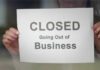 Packed Finale, Years Of Empty Days A person holding a sign that reads 'CLOSED Going Out of Business'