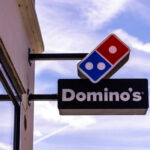 Domino’s Bold Solo Pie Lands Dominos Pizza store sign with blue sky background