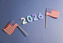 Two small American flags next to the numbers 2026 on a blue background