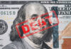 Record Debt Looms — What’s Breaking? Hundred dollar bill with red debt stamp