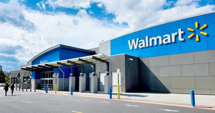 shutterstock_2448489595 Walmart store entrance with blue skies above