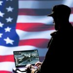 Secret Service Shakeup Stuns D.C. Silhouette of a person using a laptop before a large US flag