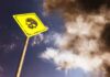 VIDEO: Gold Mine Turns Deadly — Dozens Buried Alive Yellow warning sign with skull symbol under dramatic cloudy sky