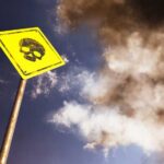 VIDEO: Gold Mine Turns Deadly — Dozens Buried Alive Yellow warning sign with skull symbol under dramatic cloudy sky