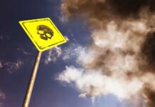 VIDEO: Gold Mine Turns Deadly — Dozens Buried Alive Yellow warning sign with skull symbol under dramatic cloudy sky
