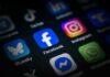 Close-up of various social media application icons on a smartphone screen