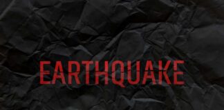 Crumpled black paper with the word 'EARTHQUAKE' in bold red letters