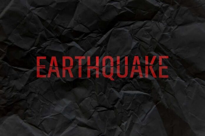 Yellow,Information,Earthquake,Sign,On,White,Background Crumpled black paper with the word 'EARTHQUAKE' in bold red letters