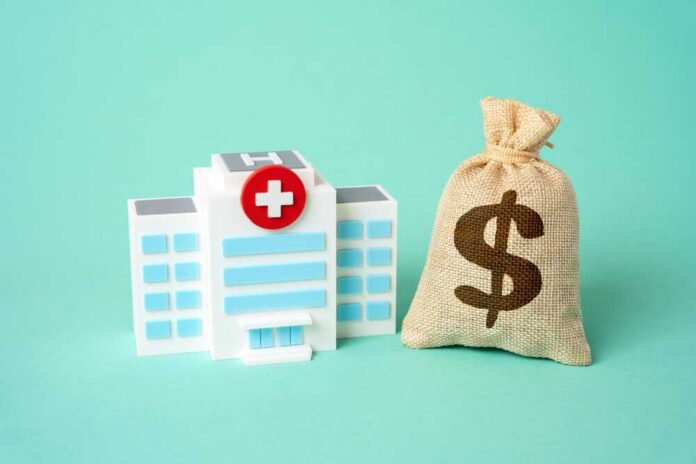 Hospital,Building,And,Dollar,Money,Bag.,Healthcare,Budget.,Investments,In A prescription pad with a stethoscope and pills nearby