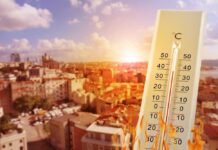 Scorching July Shatters 90-Year Heat Benchmark Thermometer displaying high temperature against a bright sun