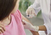 Vaccine Opt-Outs Surge — Schools On Edge Healthcare worker gives a vaccine injection in a child's upper arm