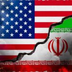 Economic D-Day: Trump Targets Iran’s Lifeline A cracked wall displaying the flags of the USA and Iran, symbolizing conflict