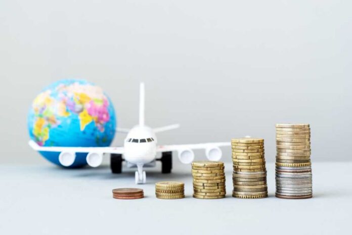 Airplane,With,A,Globe,,Growing,Stacks,Of,Coins.,Rising,Transportation Stacked coins in front of a toy airplane and globe