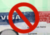 Tourist Visas Targeted — Courts Ready To Pounce US visa with prohibition symbol overlay