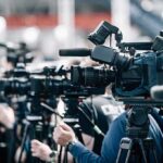 VIDEO: Deadly Festival Bloodbath Stuns Seattle Broadcast cameras on tripods at a press event