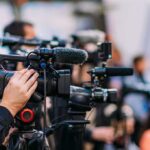 VIDEO: Gun Twist Flips Murder Case Video cameras on tripods at a media event