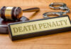 AG Pushes Death — Rolling Prison Horror Revealed Gavel handcuffs and death penalty sign on table