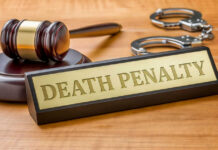 AG Pushes Death — Rolling Prison Horror Revealed Gavel handcuffs and death penalty sign on table