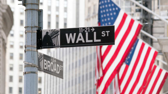 Wall,Street,Sign,In,Lower,Manhattan,New,York,,Usa Wall Street and Broad Street signs with American flags in background
