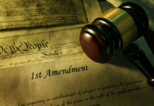 White House Ban Sparks First Amendment Clash Gavel and Constitution with 1st Amendment text.