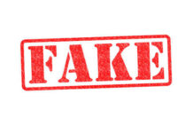 Red stamp with the word FAKE prominently displayed