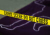 Mass Shooting Nightmares; 27 Dead Yellow crime scene tape marking off an area with a chalk outline