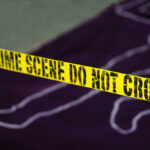 Mass Shooting Nightmares; 27 Dead Yellow crime scene tape marking off an area with a chalk outline