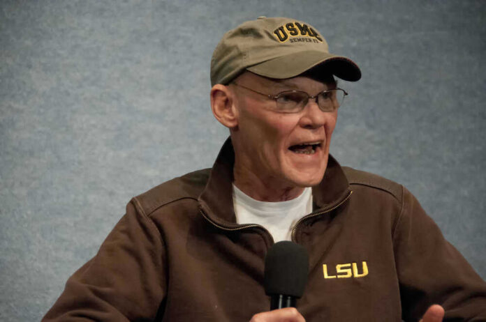 shutterstock_171951701 James Carville speaking into a microphone wearing an LSU jacket and cap