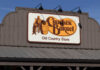 Dinner War Erupts at Cracker Barrel Sign for Cracker Barrel Old Country Store featuring a man sitting on a barrel