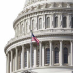 U.S. Capitol dome with American flag flying.