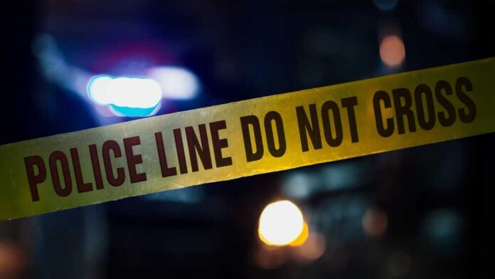 Close,Up,Shot,Focused,On,Yellow,Tape,Showing,Text,"police Police tape with blurred emergency lights in the background