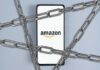 BUSTED: Amazon Angers Consumers By Doing THIS!? Close-up of an Amazon-branded shipping box tape on a cardboard box
