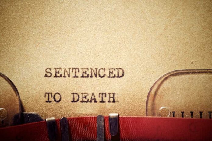 Sentenced,To,Death,Text,Written,With,A,Typewriter. Typewriter typing the phrase 'Sentenced to Death' on aged paper