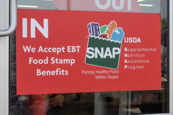 shutterstock_2314801055 Red sign accepting EBT food stamp benefits SNAP