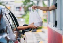 PROOF: Lib City’s Forced Pay Hike Backfires Drive-thru window handing a takeout bag to a car
