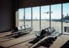 Double Failure Paralyzes Air Travel View of an airport waiting area with an airplane taking off in the background