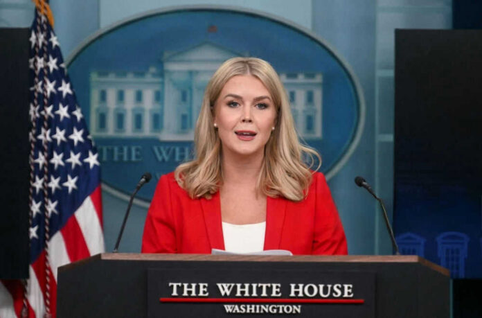 shutterstock_2596190609 Woman speaking at a White House press briefing podium