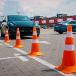 Hero Guard’s Last Stand Saves Dozens of Kids A black electric car parked near orange traffic cones in a parking lot