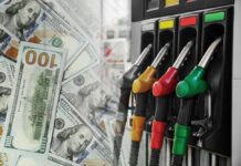 Freight Costs Explode As Diesel Spikes Fuel pump nozzles next to spread of U.S. hundred-dollar bills