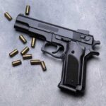 Vacation Turns Deadly: One Unattended Gun Black semi-automatic pistol with scattered brass cartridges on a gray surface