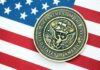 Trump’s Navy Pick Revealed Navy medal placed on an American flag background