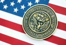 Trump’s Navy Pick Revealed Navy medal placed on an American flag background